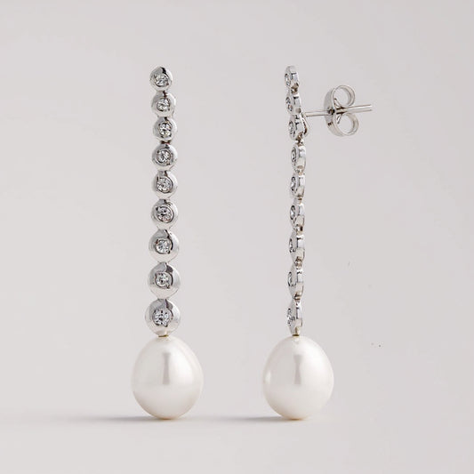 Line pearl earrings: 18 kt white gold with zirconias